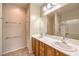 Bathroom with double sinks, cabinets, and large mirror at 2540 Binary Stars St, Henderson, NV 89044