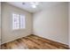 Cozy bedroom with wood flooring, ceiling fan, and plantation shutters for ample natural light at 2540 Binary Stars St, Henderson, NV 89044