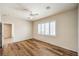 Inviting bedroom with wood flooring, ceiling fan, and shuttered window to let in natural light at 2540 Binary Stars St, Henderson, NV 89044
