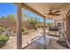 Covered patio with ceiling fan and barbecue area, overlooking a well-maintained landscaped backyard at 2540 Binary Stars St, Henderson, NV 89044