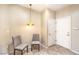 Inviting entryway featuring decorative pendant light, two chairs and access to garage at 2540 Binary Stars St, Henderson, NV 89044