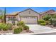 Inviting front yard showcasing xeriscaping and a well-maintained two-car garage at 2540 Binary Stars St, Henderson, NV 89044