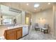 Open kitchen area with double sink, oak cabinets and tile flooring at 2540 Binary Stars St, Henderson, NV 89044