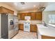 Functional kitchen with stainless steel refrigerator and wood cabinetry at 2540 Binary Stars St, Henderson, NV 89044