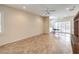 Bright living room with tile flooring, ceiling fan, and sliding glass doors to backyard at 2540 Binary Stars St, Henderson, NV 89044
