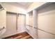 Spacious walk-in closet featuring laminate floors, rod and shelf storage, and natural light at 2540 Binary Stars St, Henderson, NV 89044