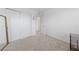 Carpeted bedroom with a mirrored closet and adjacent bedroom doorway at 2732 Roman Palm Rd, North Las Vegas, NV 89086