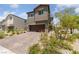 Two-story home with a brick driveway, desert landscaping, and an attached two-car garage at 2732 Roman Palm Rd, North Las Vegas, NV 89086