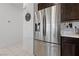 Stainless steel refrigerator in a well-designed kitchen with dark cabinetry and modern finishes at 2732 Roman Palm Rd, North Las Vegas, NV 89086