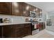 Well-equipped kitchen featuring dark cabinets, stainless steel appliances, and ample counter space at 2732 Roman Palm Rd, North Las Vegas, NV 89086