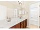 Bathroom featuring dual sinks, large mirror and a view of the shower and tub at 2755 Asgard Ave, Las Vegas, NV 89121