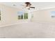 Expansive bedroom with neutral carpeting, ceiling fan, and bright natural light from multiple windows at 2755 Asgard Ave, Las Vegas, NV 89121