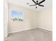 A carpeted bedroom with a ceiling fan and bright window at 2755 Asgard Ave, Las Vegas, NV 89121