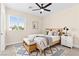 Cozy staged bedroom with a bed, bench, rug, and ceiling fan at 2755 Asgard Ave, Las Vegas, NV 89121