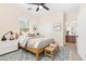 Staged bedroom with bed, rug, lamp, ceiling fan, and a bathroom adjacent at 2755 Asgard Ave, Las Vegas, NV 89121