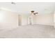 Spacious bedroom with neutral carpeting, ceiling fan, and ample doorway access to other areas of the home at 2755 Asgard Ave, Las Vegas, NV 89121