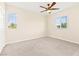 Empty bedroom featuring carpeted floor, ceiling fan, and large windows at 2755 Asgard Ave, Las Vegas, NV 89121