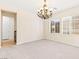 Elegant dining room with a chandelier and natural light from two large windows at 2755 Asgard Ave, Las Vegas, NV 89121