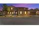 Front exterior of the home at night, showcasing stone accents, warm lighting, and a landscaped yard for welcoming curb appeal at 2755 Asgard Ave, Las Vegas, NV 89121