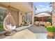Cozy front porch with a hanging chair and comfortable seating, creating a relaxing and inviting outdoor space at 2755 Asgard Ave, Las Vegas, NV 89121