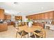 Spacious kitchen with wood cabinets, a central island with bar seating, and modern appliances for culinary enthusiasts at 2755 Asgard Ave, Las Vegas, NV 89121