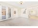 Bright living room features carpeted floors, staircase and glass patio doors at 2755 Asgard Ave, Las Vegas, NV 89121