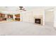 Open concept living area with fireplace, carpeted floors, and direct access to the kitchen at 2755 Asgard Ave, Las Vegas, NV 89121