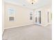 Large carpeted living room with natural light and patio access through double doors at 2755 Asgard Ave, Las Vegas, NV 89121