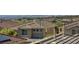 An elevated view highlights this tan home's roof within a vibrant neighborhood and distant city skyline at 2856 Trossachs St, Henderson, NV 89044