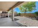 Spacious backyard featuring low-maintenance gravel, privacy wall, and covered patio at 2856 Trossachs St, Henderson, NV 89044
