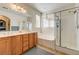 Bathroom featuring double sinks, a soaking tub, and a separate glass-enclosed shower at 2856 Trossachs St, Henderson, NV 89044