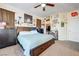 Bedroom with a ceiling fan, carpet floors, walk-in closet, and a large bed with drawers at 2856 Trossachs St, Henderson, NV 89044