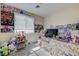 Bedroom with a large window, carpet floors, and lots of posters at 2856 Trossachs St, Henderson, NV 89044