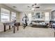 Spacious bonus room with a ceiling fan, game table, and comfortable seating area at 2856 Trossachs St, Henderson, NV 89044
