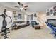 Versatile bonus room with exercise equipment, casual seating, and natural light at 2856 Trossachs St, Henderson, NV 89044