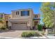 Inviting two-story home featuring a two-car garage and well-maintained front yard with shrubs at 2856 Trossachs St, Henderson, NV 89044