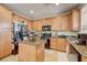 Kitchen with granite counters, island, stainless steel appliances, and wood cabinets at 2856 Trossachs St, Henderson, NV 89044