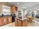 Open kitchen connected to dining area, featuring wood cabinets and granite countertops at 2856 Trossachs St, Henderson, NV 89044