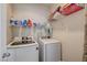 Well-lit laundry room with modern washer and dryer and plenty of storage space at 2856 Trossachs St, Henderson, NV 89044