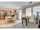 Bright living room featuring a foosball table, windows, and access to the patio at 2856 Trossachs St, Henderson, NV 89044