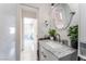 Elegant bathroom featuring marble-like walls, a round mirror, and a modern vanity at 2990 Carnelian St, Las Vegas, NV 89121