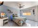 Bedroom featuring tile floors, a ceiling fan, and a large window at 2990 Carnelian St, Las Vegas, NV 89121