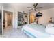 Bright bedroom with a ceiling fan, a mirrored closet, and an en-suite bathroom at 2990 Carnelian St, Las Vegas, NV 89121