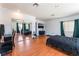 Large bedroom features wood-look floors, a mirrored closet, and black furniture and accents at 2990 Carnelian St, Las Vegas, NV 89121