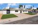 Attractive single-Gathering home with vibrant green lawn and a large driveway for multiple vehicles at 2990 Carnelian St, Las Vegas, NV 89121