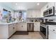 Modern kitchen with white cabinetry, stainless steel appliances, and stylish backsplash, perfect for cooking at 2990 Carnelian St, Las Vegas, NV 89121