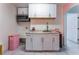 Charming kitchenette featuring white cabinets, granite counters, and a stainless steel microwave at 2990 Carnelian St, Las Vegas, NV 89121
