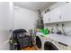 Laundry room featuring washer, dryer, storage shelving, and modern fixtures for convenience at 2990 Carnelian St, Las Vegas, NV 89121