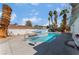 Inviting backyard pool with a sunshade and desert landscaping at 2990 Carnelian St, Las Vegas, NV 89121