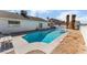 Inviting backyard pool surrounded by a concrete deck and rock landscaping at 2990 Carnelian St, Las Vegas, NV 89121